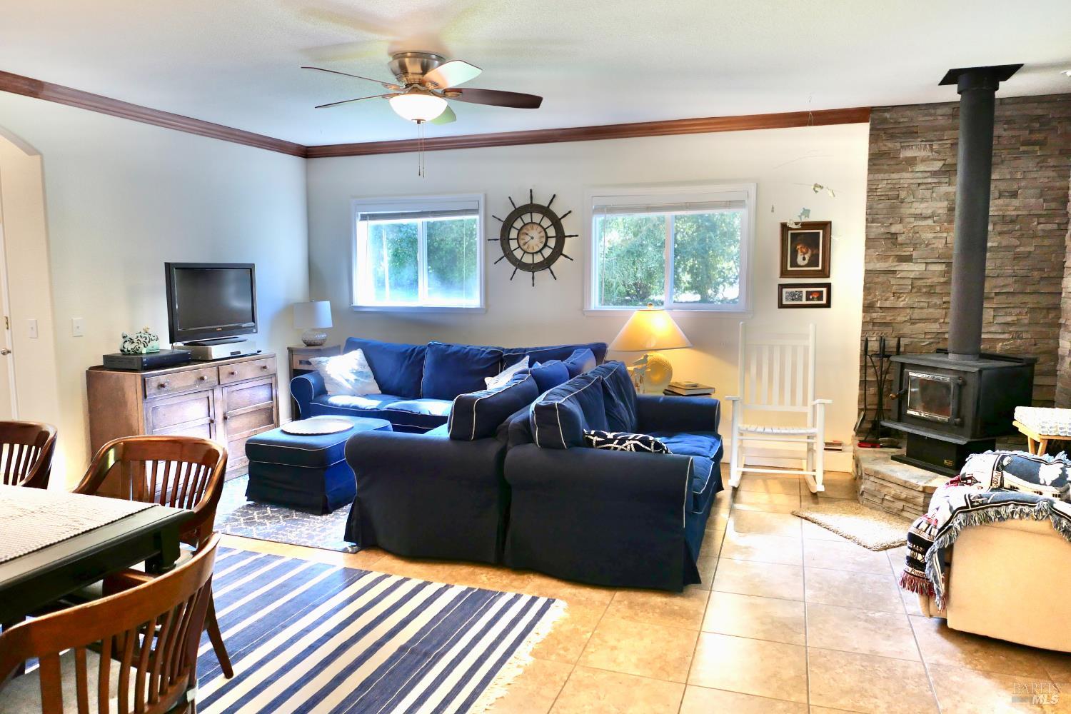 30860 Simpson Lane Fort Bragg, CA 95437 - Photo 8 of 33 a living room with furniture a fireplace and a flat screen tv