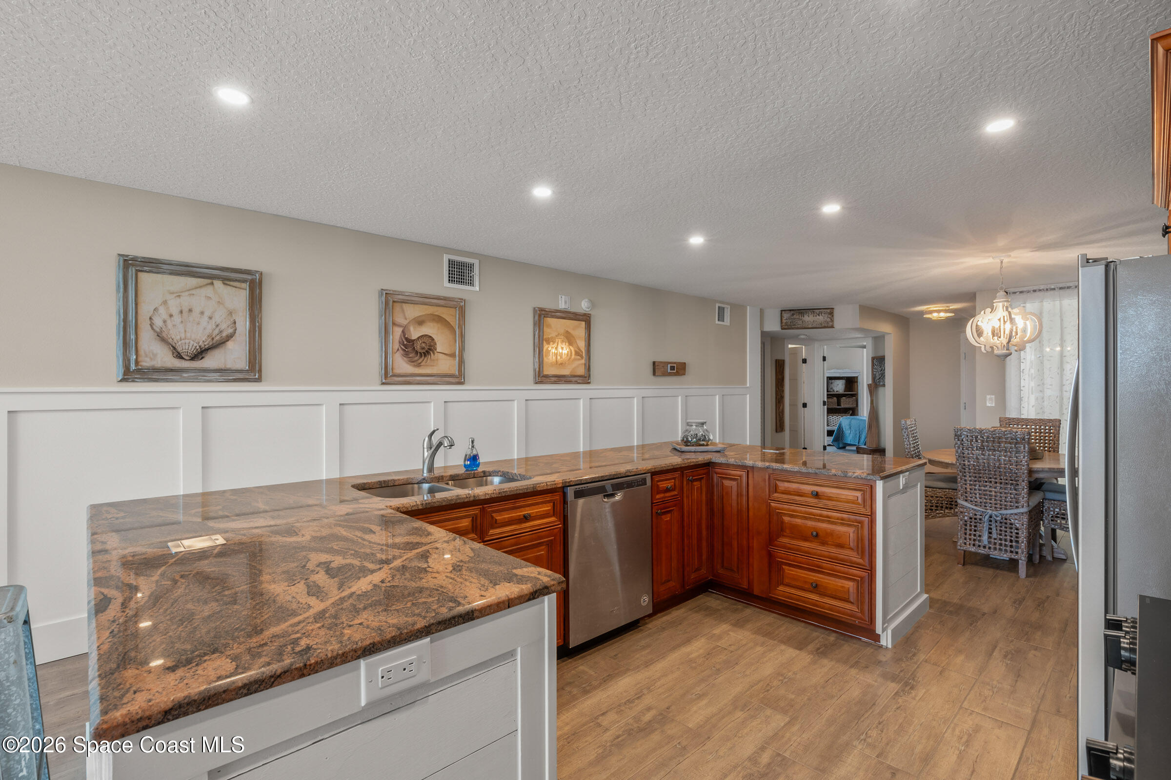 700 Wave Crest Avenue, Unit 206 Indialantic, FL 32903 - Photo 12 of 36 a kitchen with stainless steel appliances granite countertop a sink and cabinets
