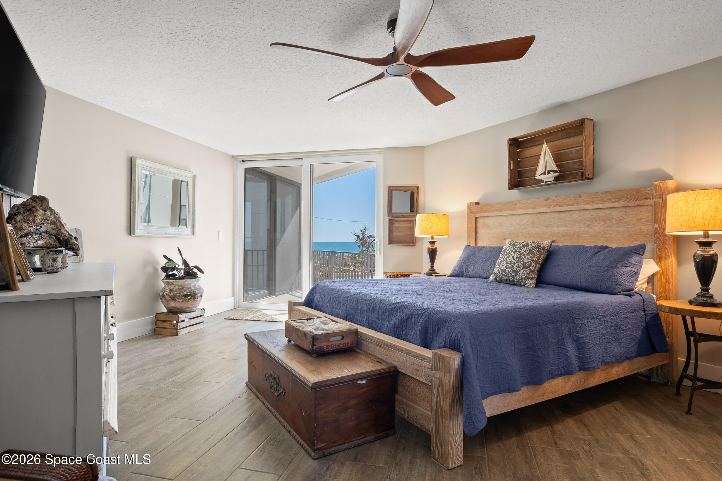 700 Wave Crest Avenue, Unit 206 Indialantic, FL 32903 - Photo 20 of 36 a bedroom with a bed couch and window