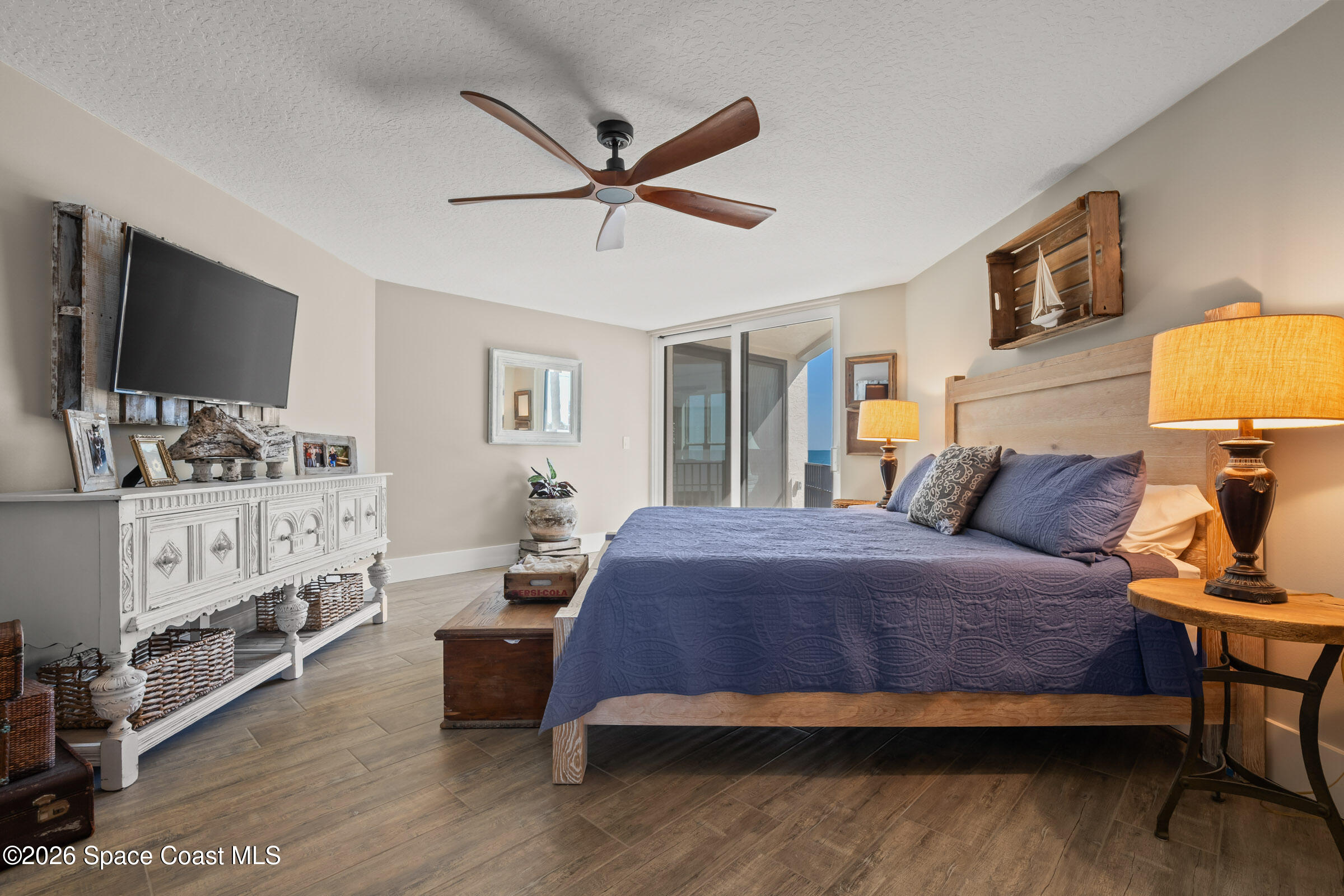 700 Wave Crest Avenue, Unit 206 Indialantic, FL 32903 - Photo 21 of 36 a bedroom with a bed a flat screen tv and dresser