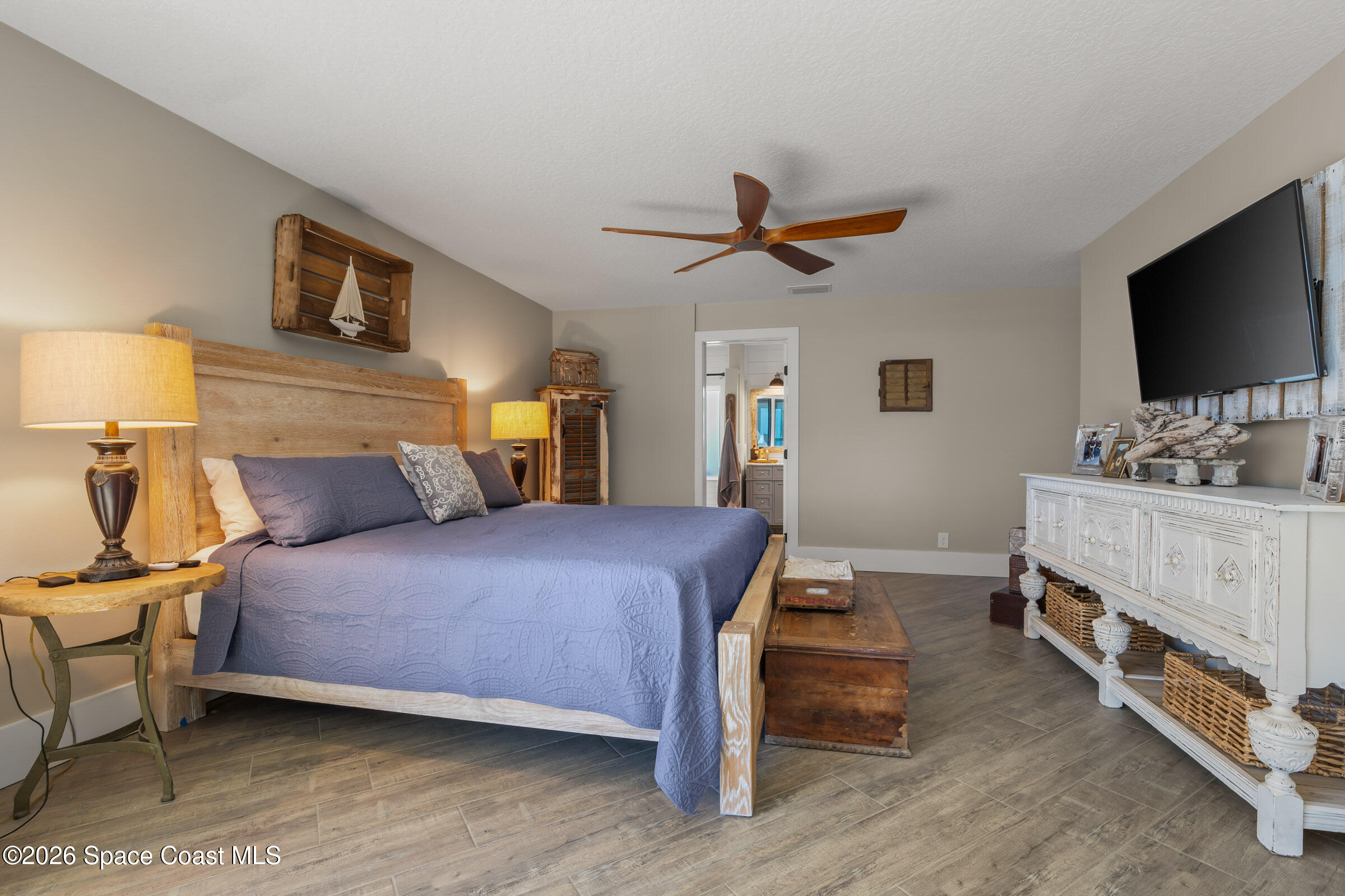 700 Wave Crest Avenue, Unit 206 Indialantic, FL 32903 - Photo 22 of 36 a bedroom with a bed and a flat screen tv