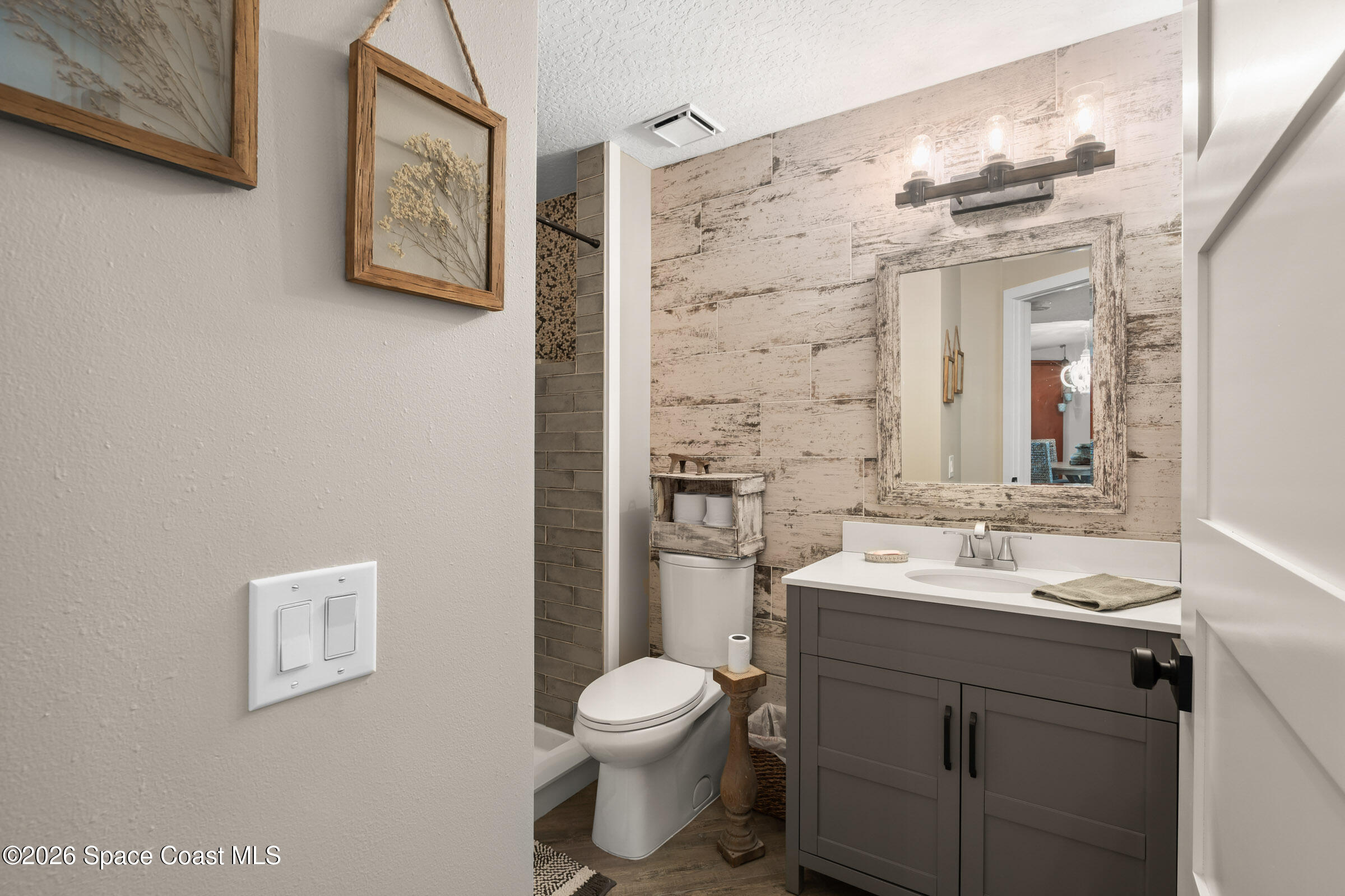 700 Wave Crest Avenue, Unit 206 Indialantic, FL 32903 - Photo 27 of 36 a bathroom with a toilet sink and mirror