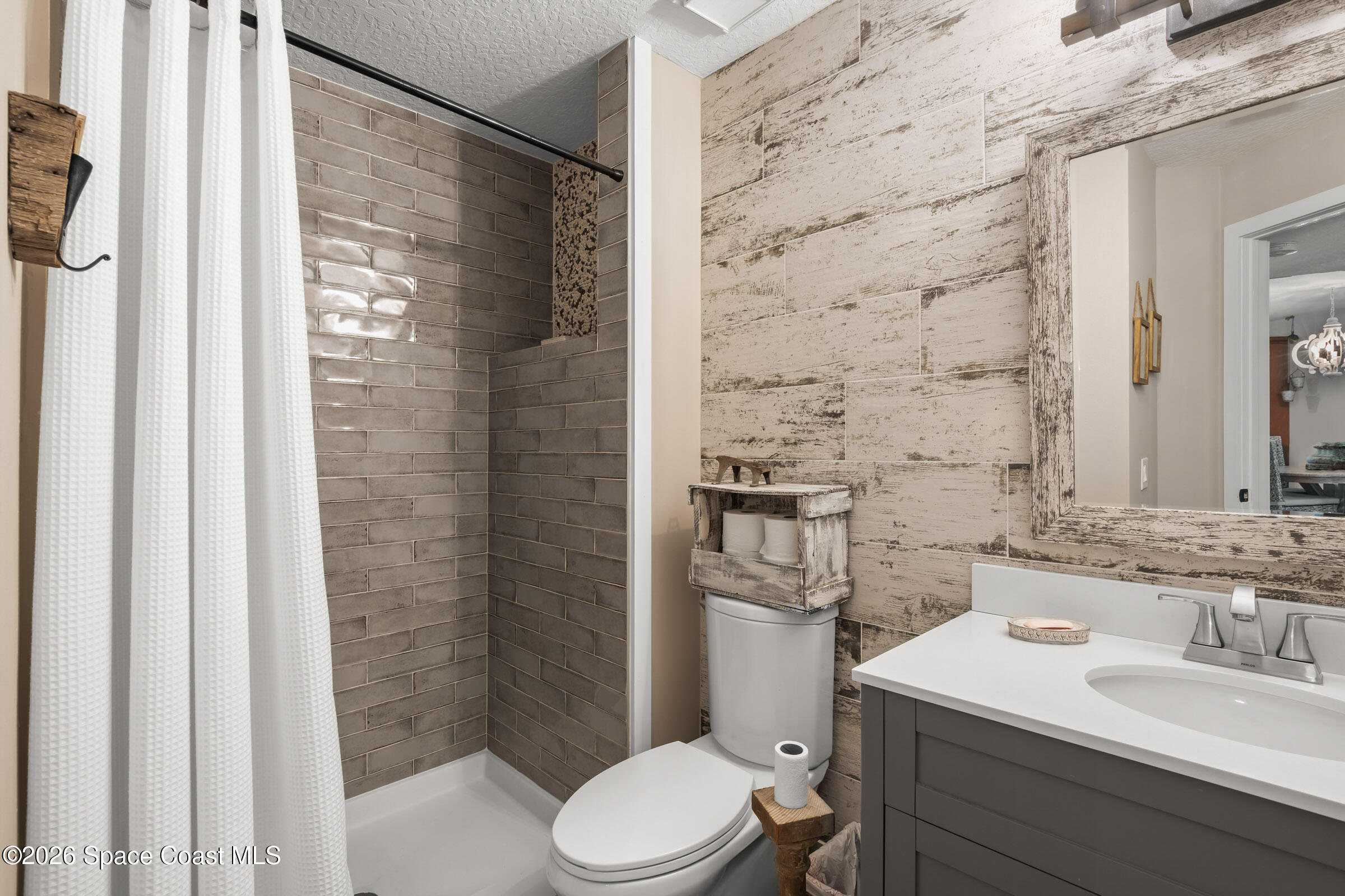 700 Wave Crest Avenue, Unit 206 Indialantic, FL 32903 - Photo 28 of 36 a bathroom with a sink a toilet and shower