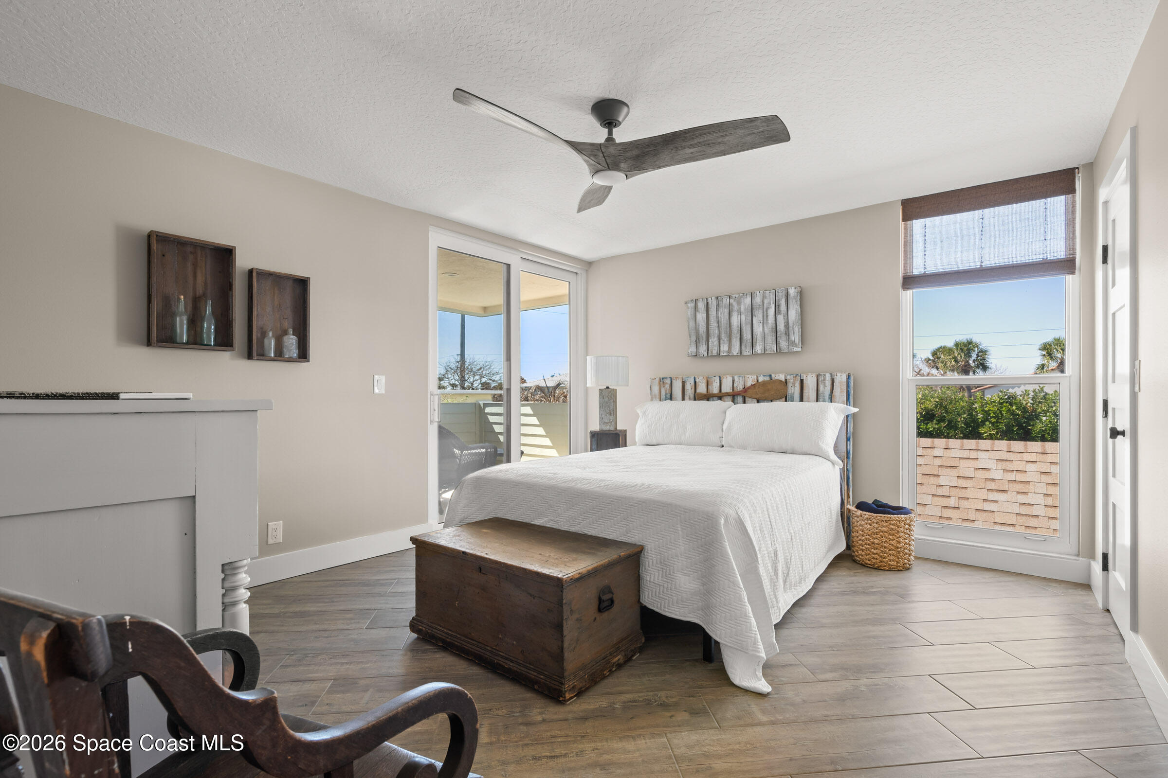 700 Wave Crest Avenue, Unit 206 Indialantic, FL 32903 - Photo 29 of 36 a spacious bedroom with a bed and a flat screen tv