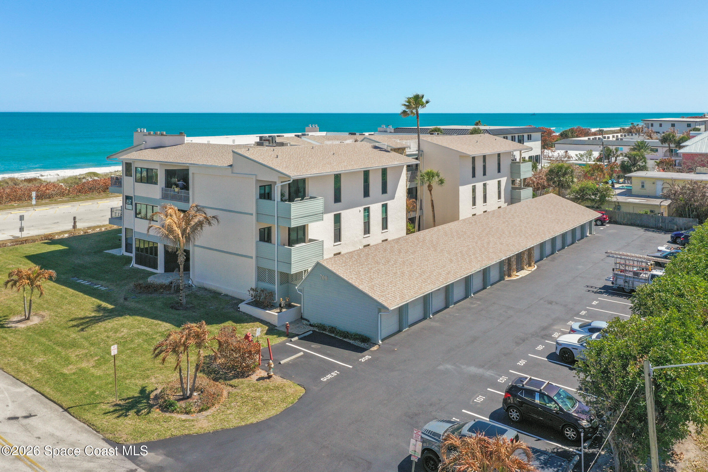 700 Wave Crest Avenue, Unit 206 Indialantic, FL 32903 - Photo 3 of 36 a terrace with a table and chairs