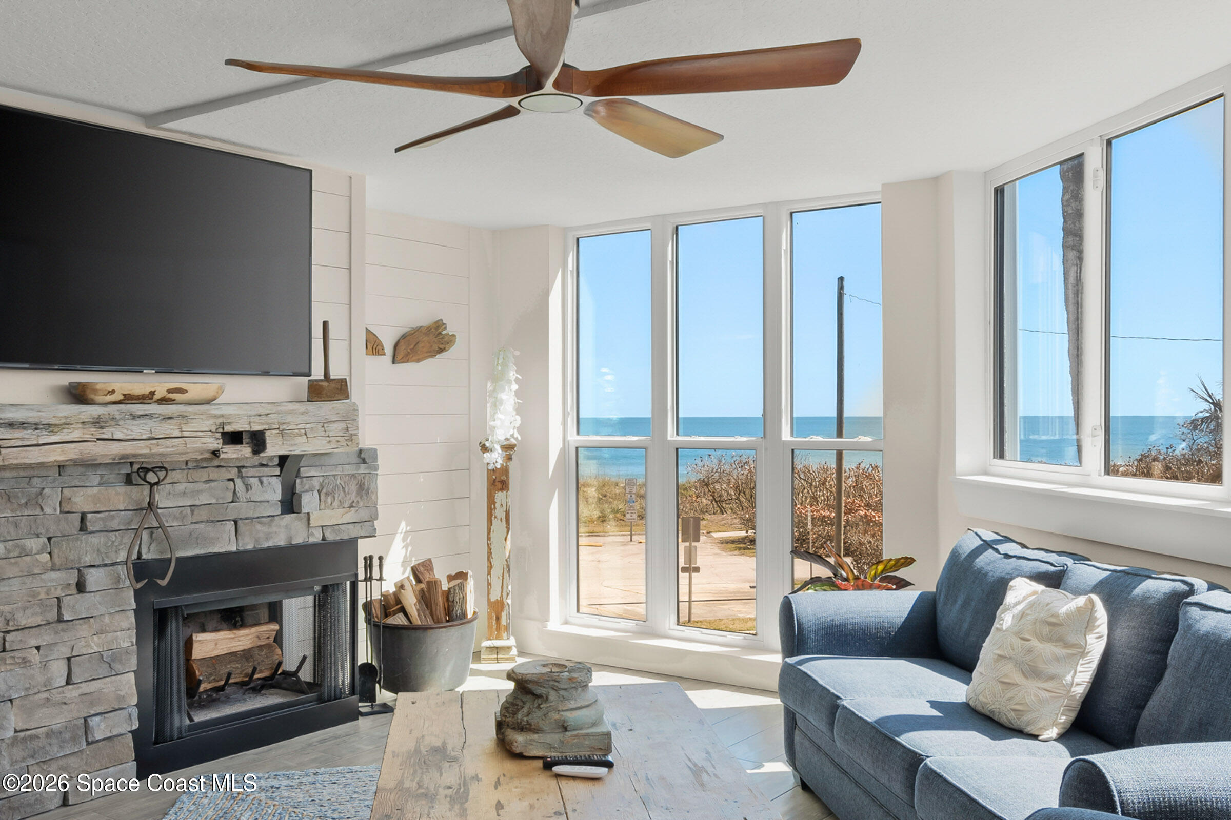 700 Wave Crest Avenue, Unit 206 Indialantic, FL 32903 - Photo 5 of 36 a living room with furniture and a fireplace