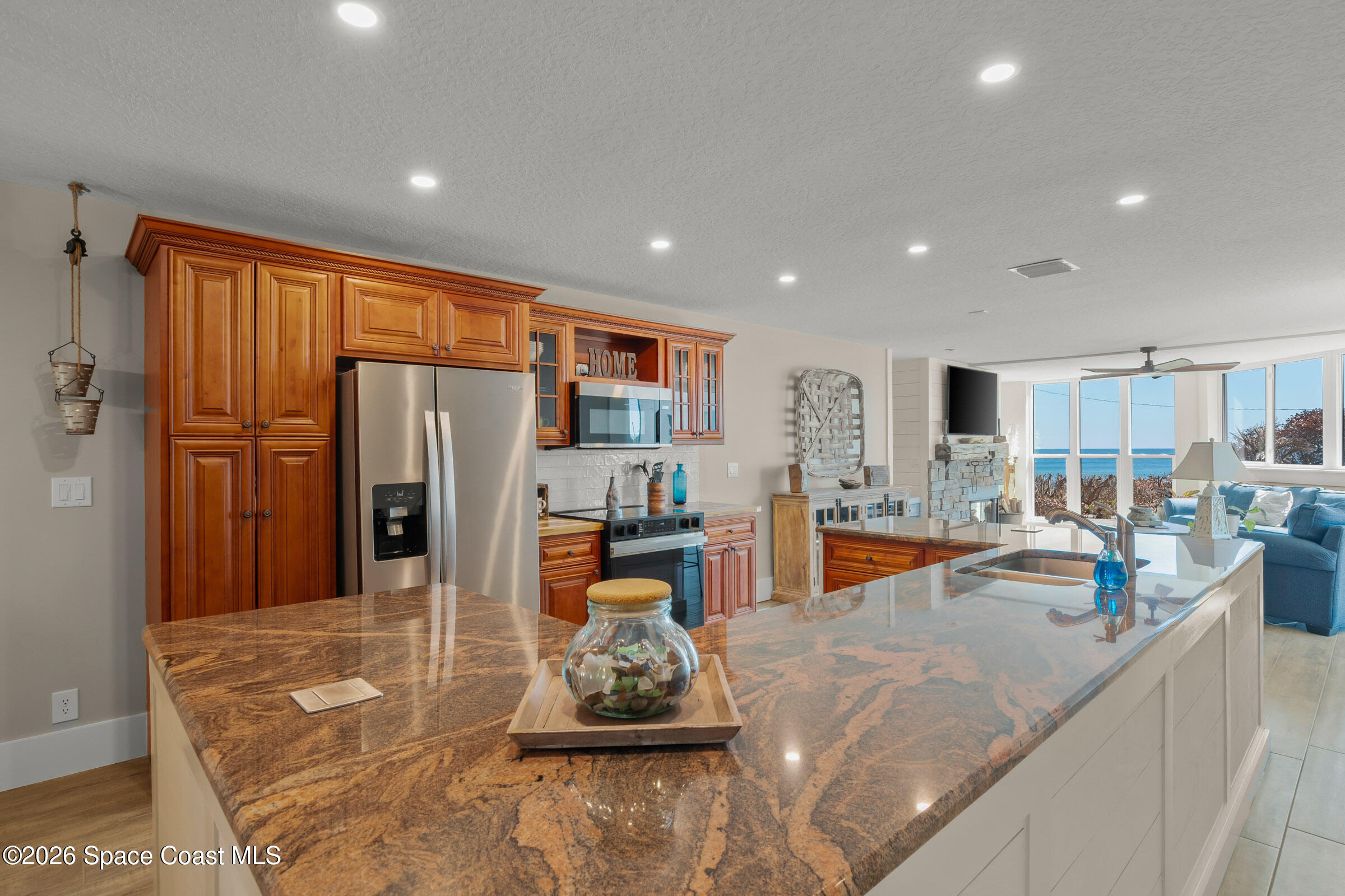 700 Wave Crest Avenue, Unit 206 Indialantic, FL 32903 - Photo 7 of 36 a kitchen with stainless steel appliances granite countertop a refrigerator and a sink