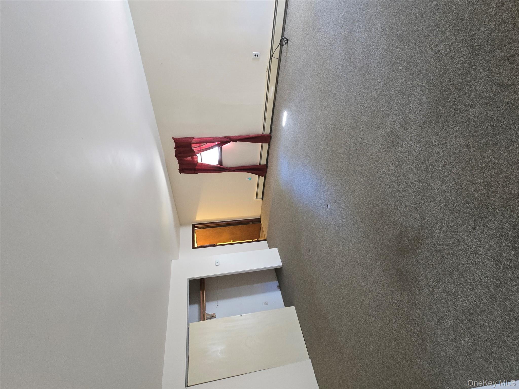 32 Genung Street, Unit 2 Middletown, NY 10940 - Photo 5 of 9 Carpeted spare room featuring a baseboard radiator