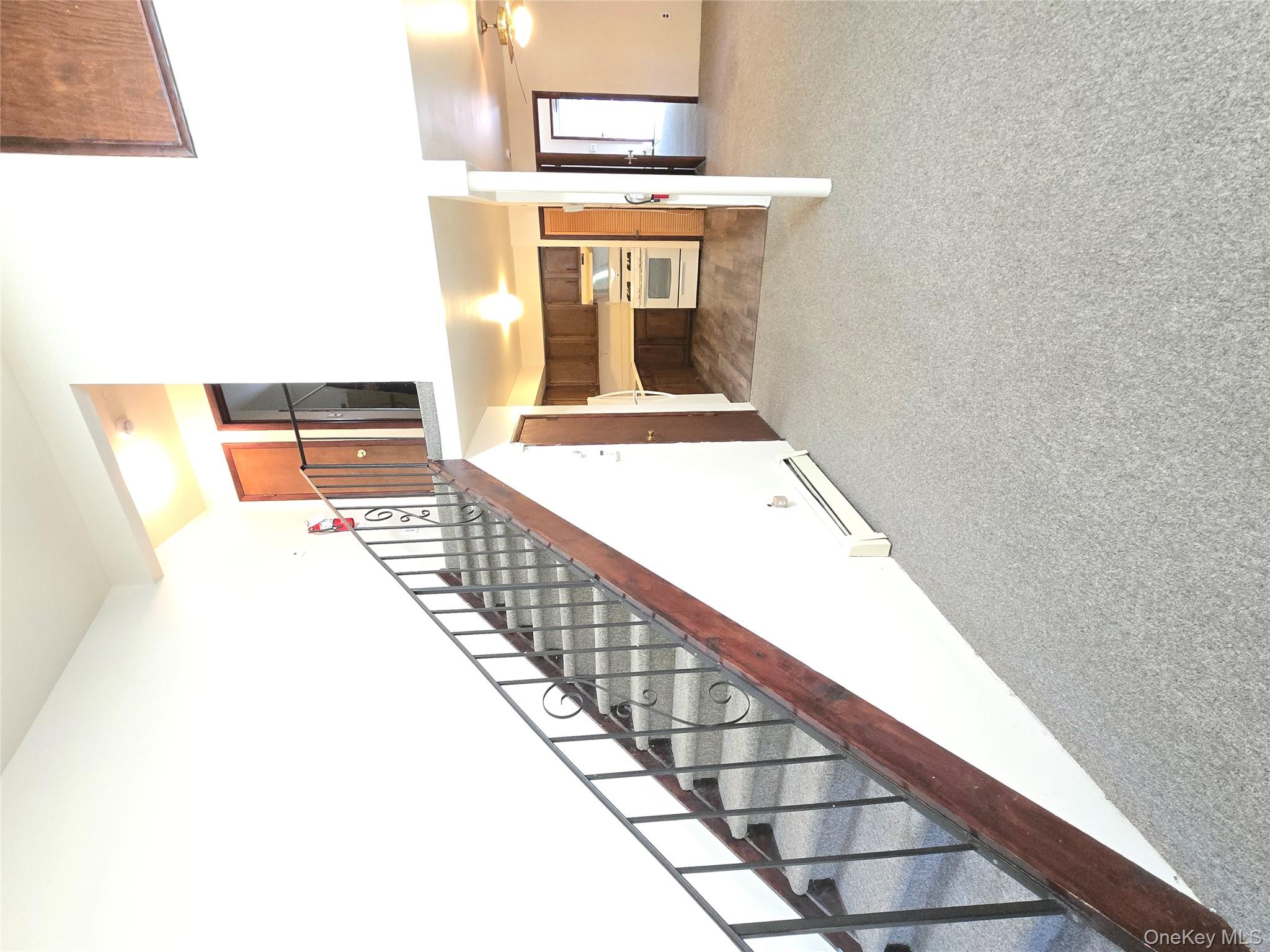 32 Genung Street, Unit 2 Middletown, NY 10940 - Photo 6 of 9 Stairway featuring carpet flooring, baseboard heating, and ceiling fan