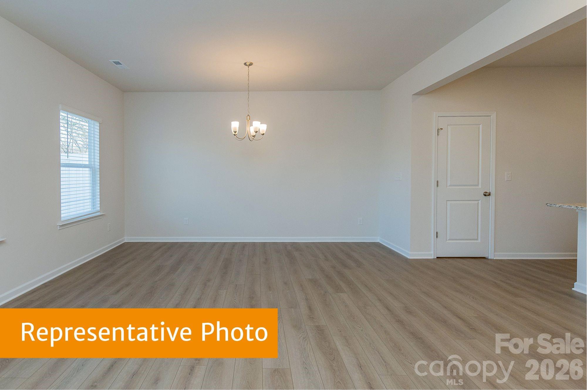 6104 Jasmine Br Road Charlotte, NC 28216 - Photo 16 of 36 an empty room with wooden floor