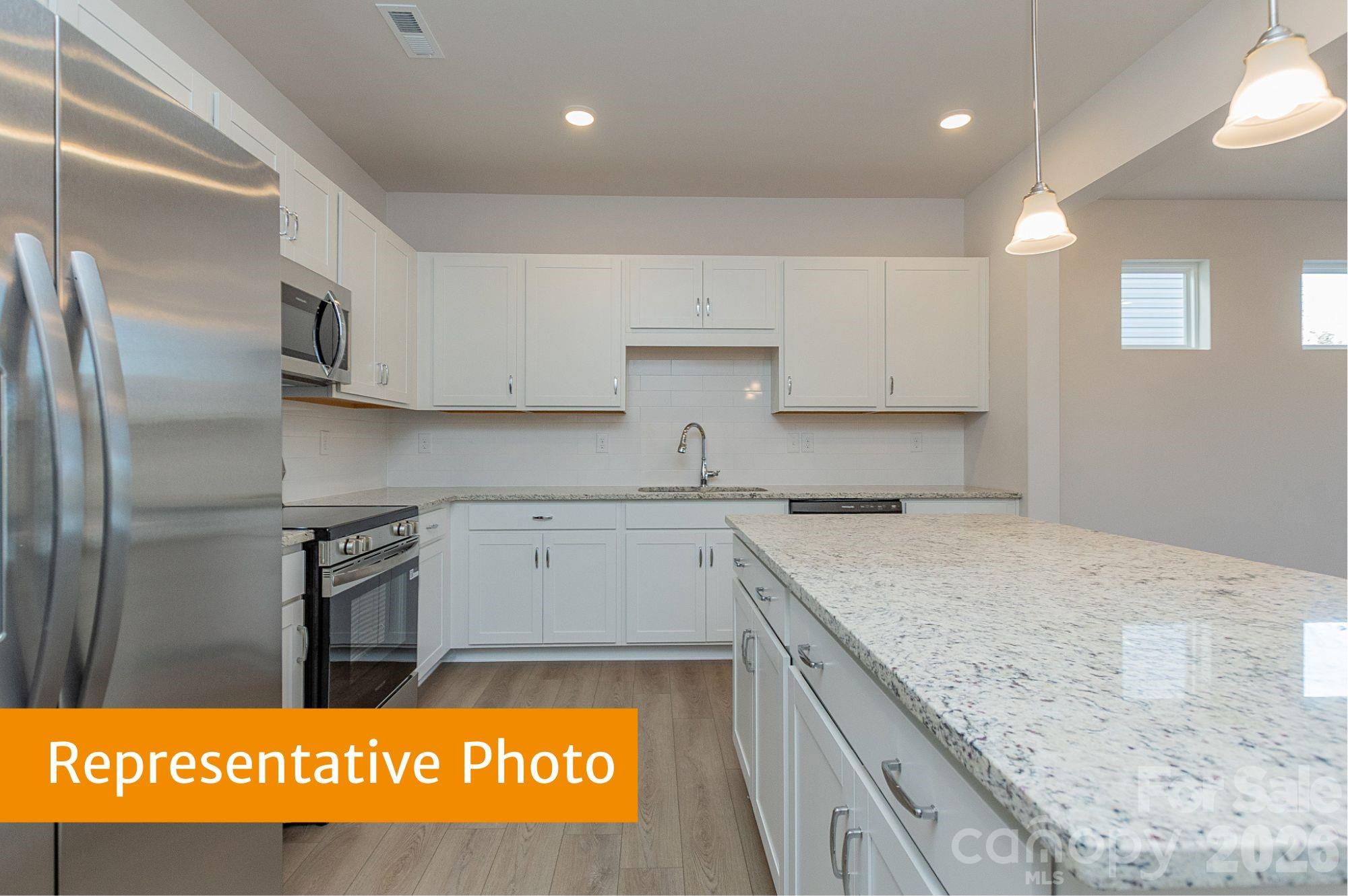 6104 Jasmine Br Road Charlotte, NC 28216 - Photo 4 of 36 a kitchen with stainless steel appliances granite countertop a sink stove and refrigerator