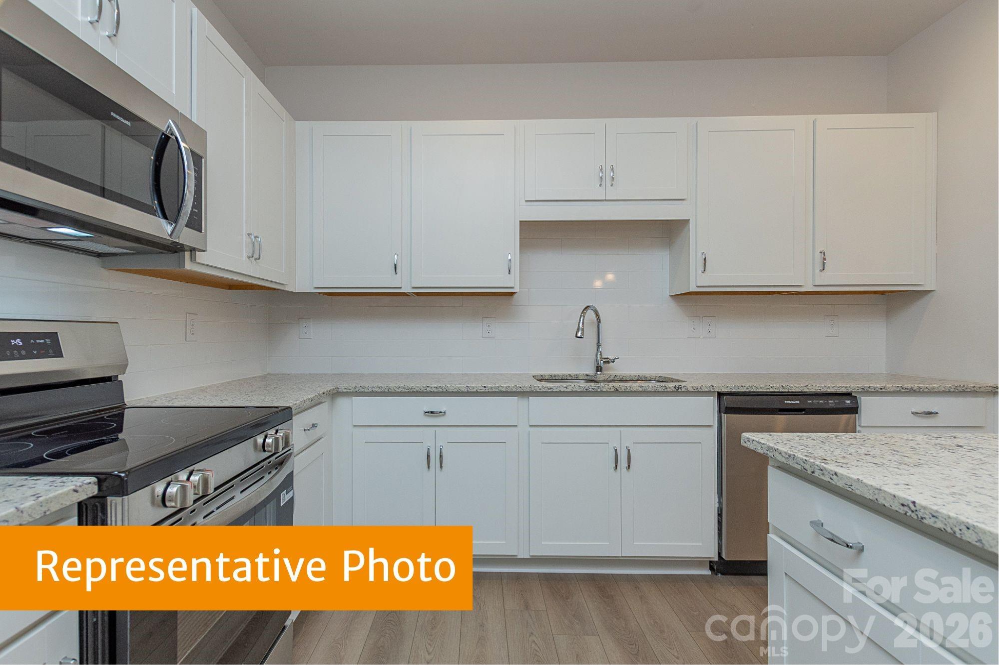 6104 Jasmine Br Road Charlotte, NC 28216 - Photo 5 of 36 a kitchen with stainless steel appliances granite countertop a sink and cabinets