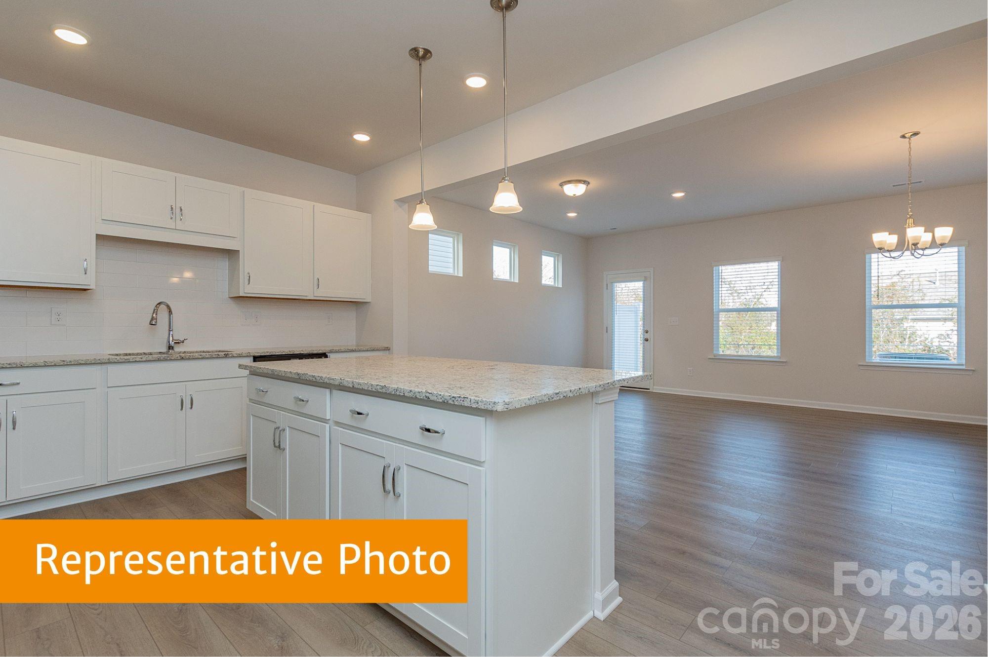 6104 Jasmine Br Road Charlotte, NC 28216 - Photo 6 of 36 a kitchen with stainless steel appliances granite countertop a sink and cabinets