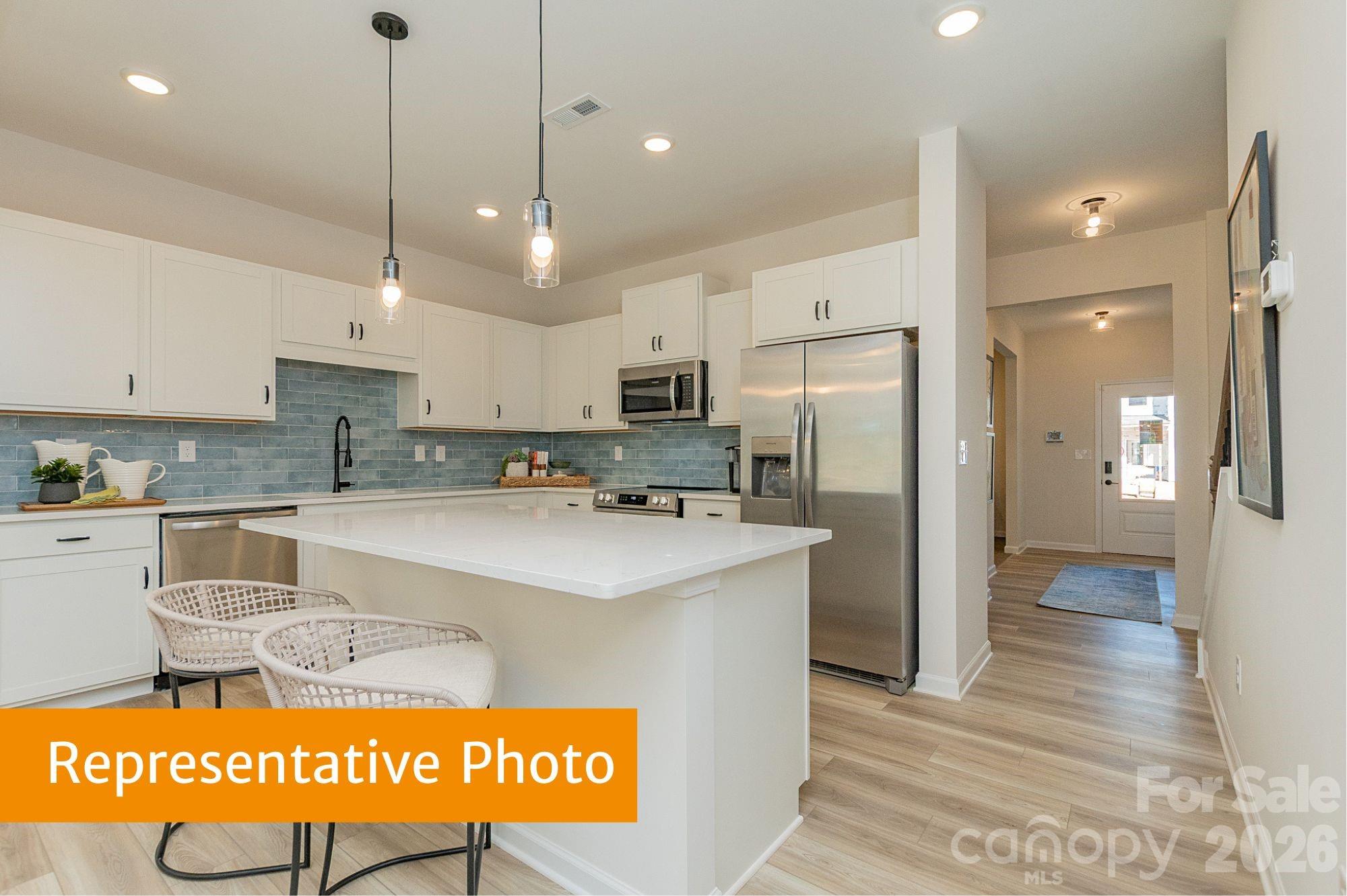 6104 Jasmine Br Road Charlotte, NC 28216 - Photo 8 of 36 a kitchen with stainless steel appliances granite countertop a refrigerator a sink and a stove