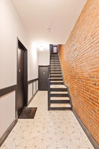 a view of entryway and hall with wooden floor