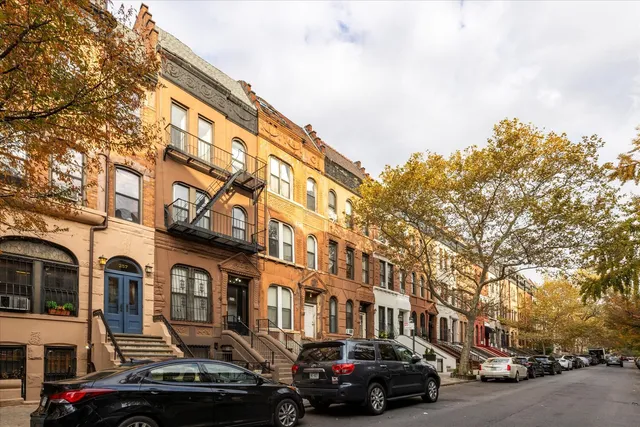 a couple of cars parked in front of a building