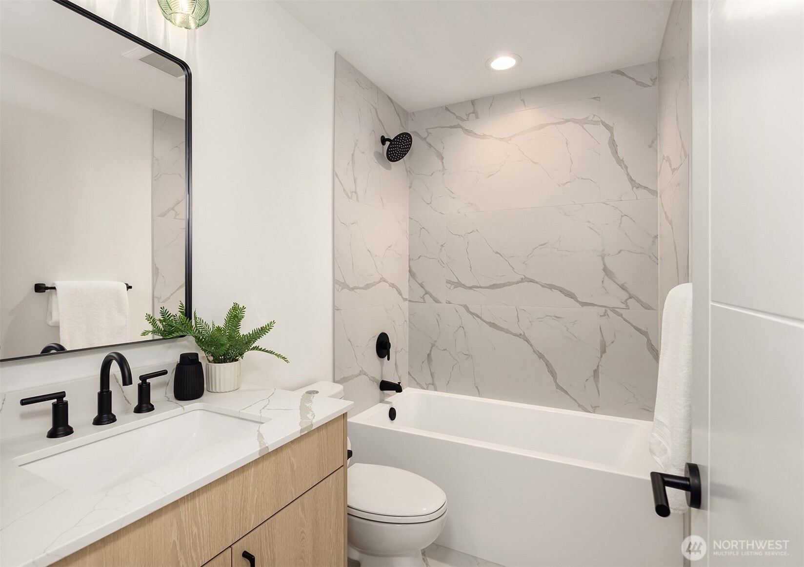 2340 North 64th Street, Unit A Seattle, WA 98103 - Photo 12 of 29 a bathroom with a sink a toilet a tub and shower