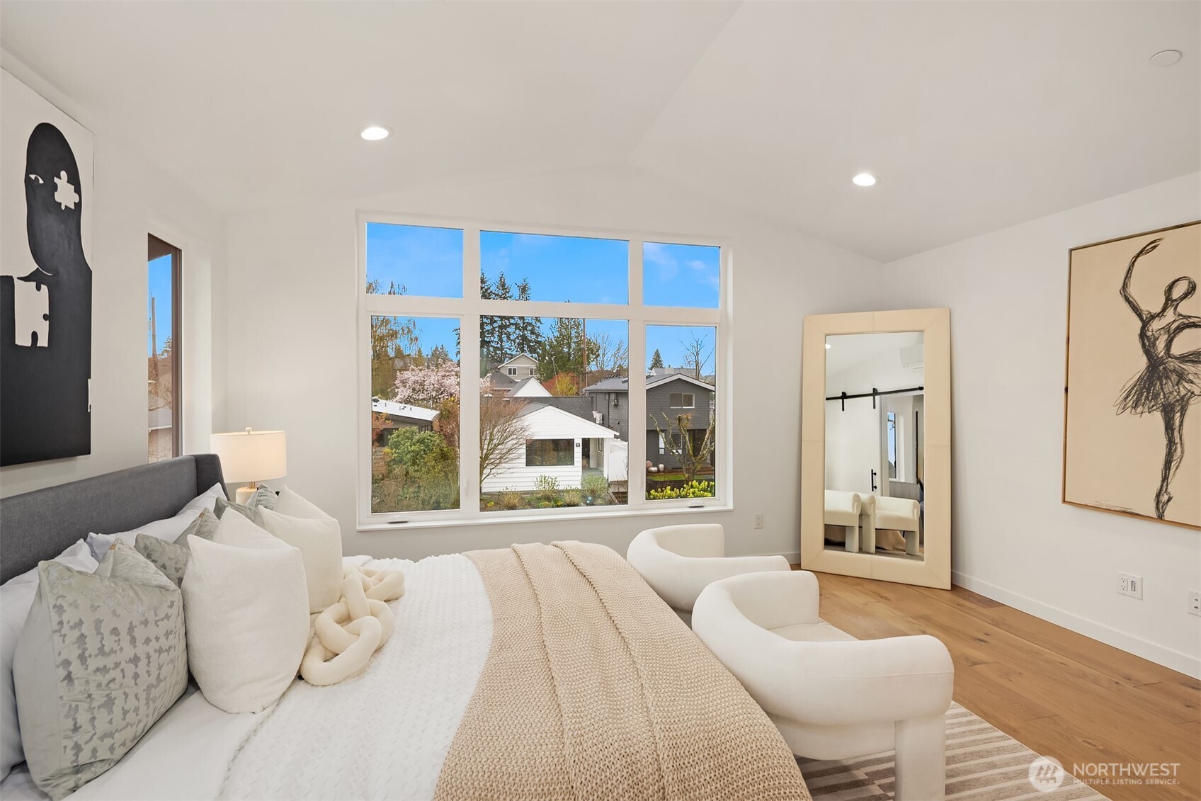 2340 North 64th Street, Unit A Seattle, WA 98103 - Photo 19 of 29 a spacious bedroom with a large bed and a large window
