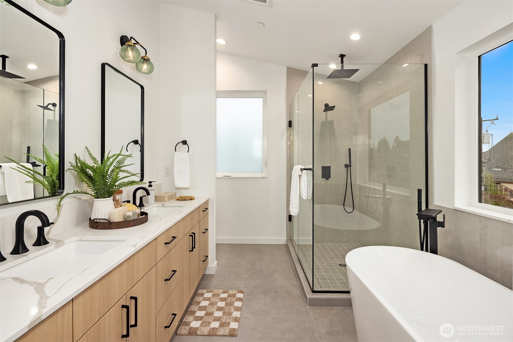 2340 North 64th Street, Unit A Seattle, WA 98103 - Photo 20 of 29 a bathroom with a double vanity sink toilet mirror and shower