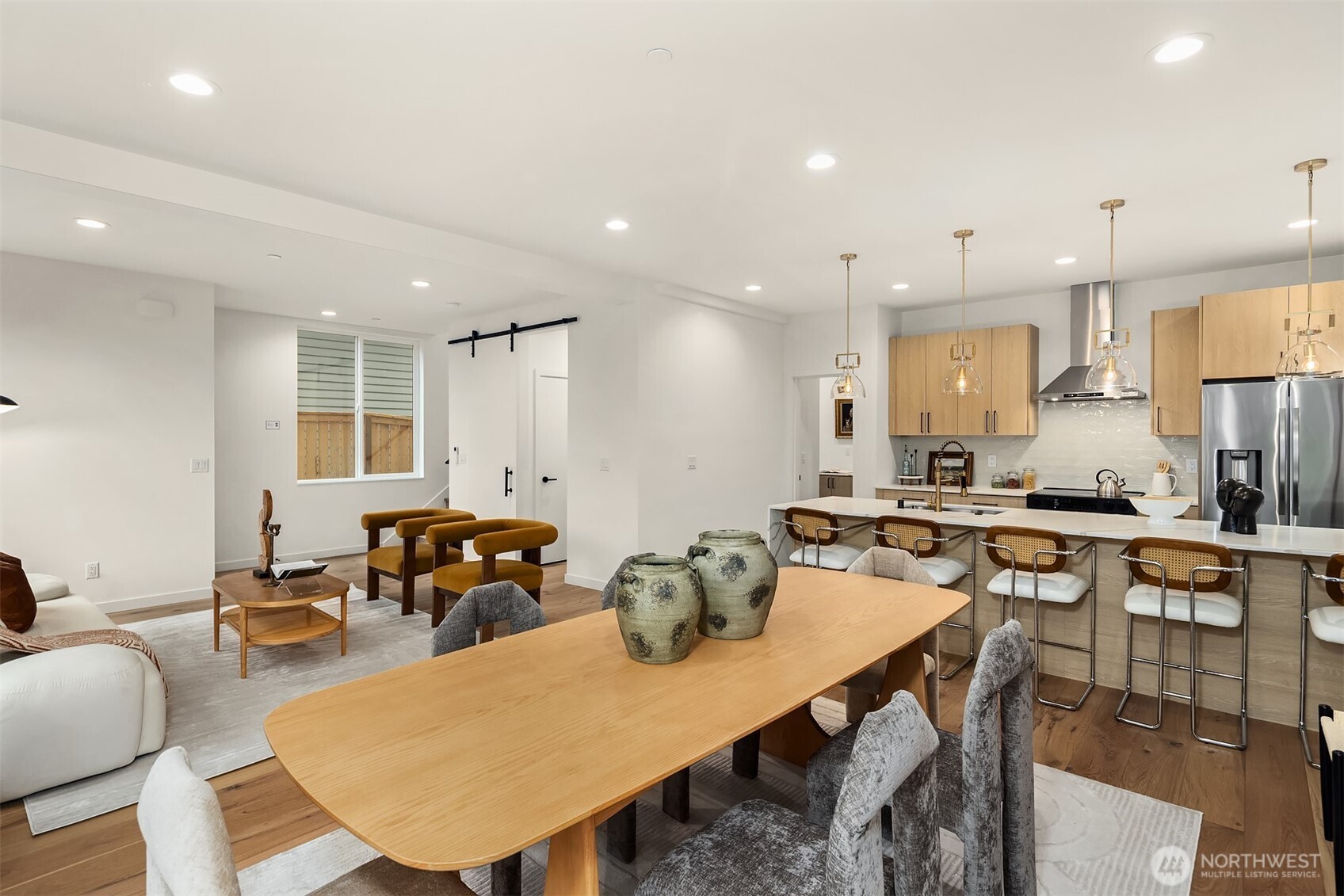 2340 North 64th Street, Unit A Seattle, WA 98103 - Photo 6 of 29 a kitchen with a table chairs stove and white cabinets