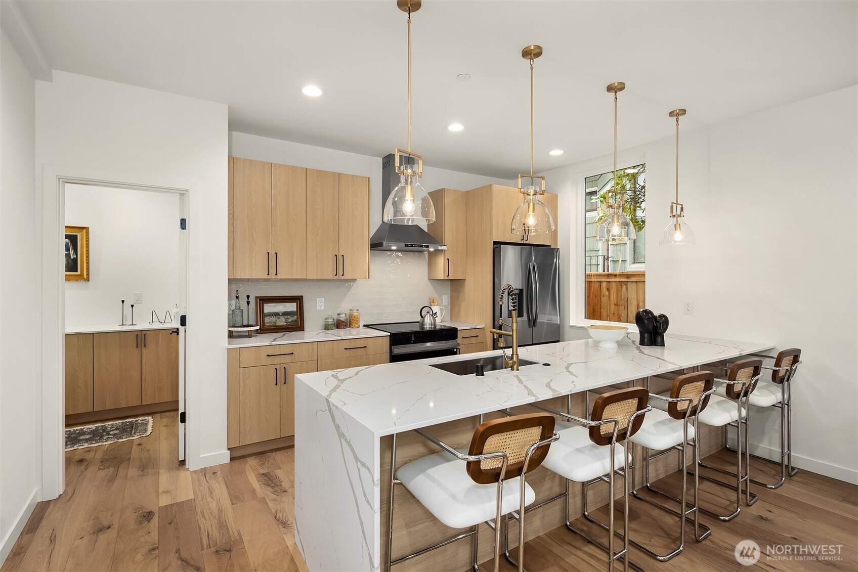 2340 North 64th Street, Unit A Seattle, WA 98103 - Photo 7 of 29 a kitchen with kitchen island a stove a table and chairs in it