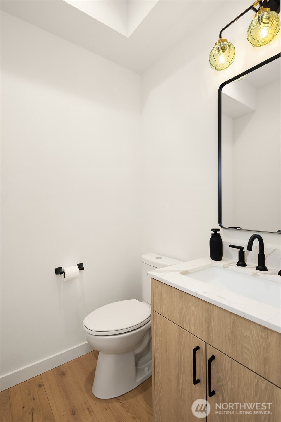 2340 North 64th Street, Unit A Seattle, WA 98103 - Photo 10 of 29 a bathroom with a sink a toilet and mirror