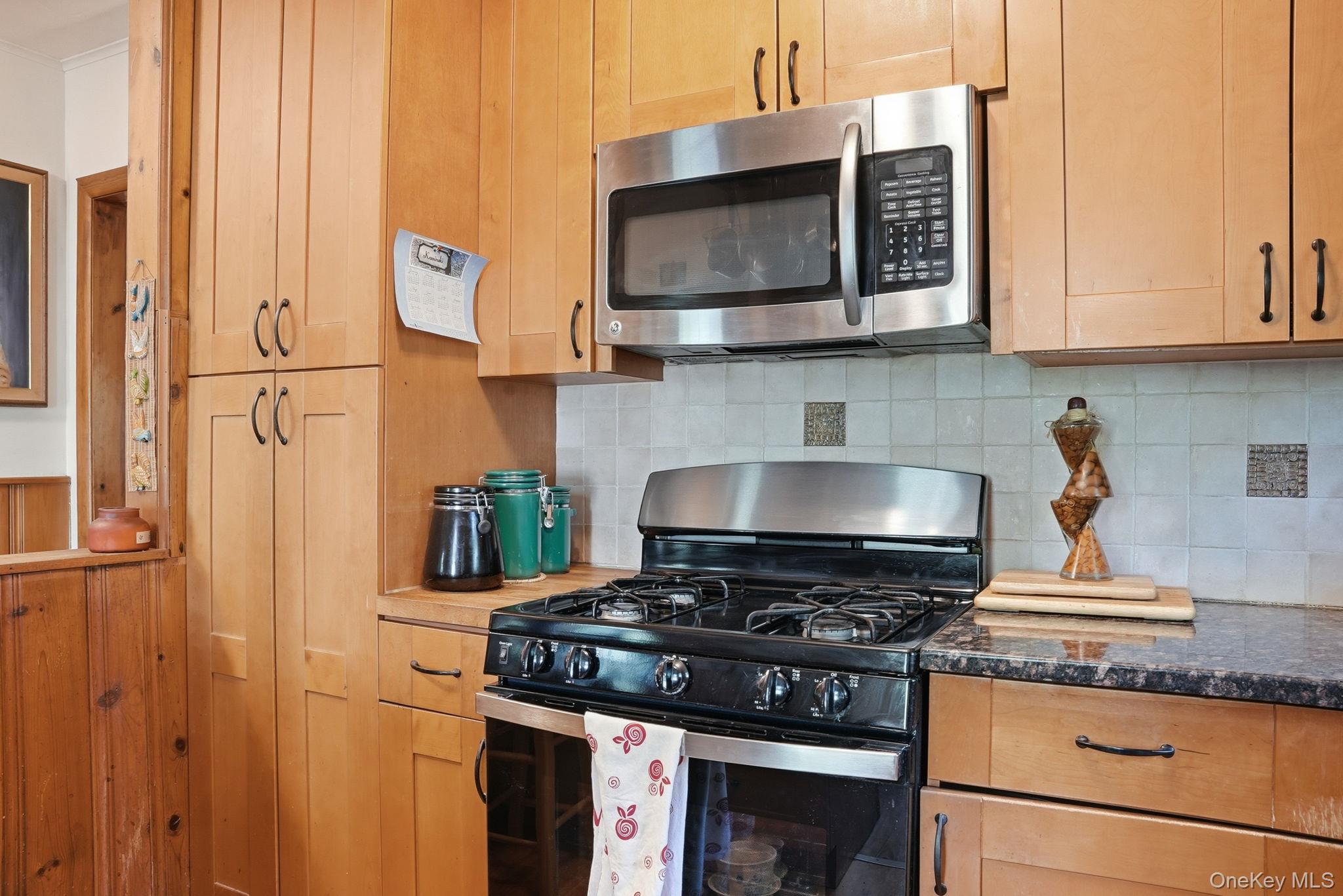 370 Starlight Road Monticello, NY 12701 - Photo 18 of 49 a kitchen with stainless steel appliances granite countertop a stove and a microwave
