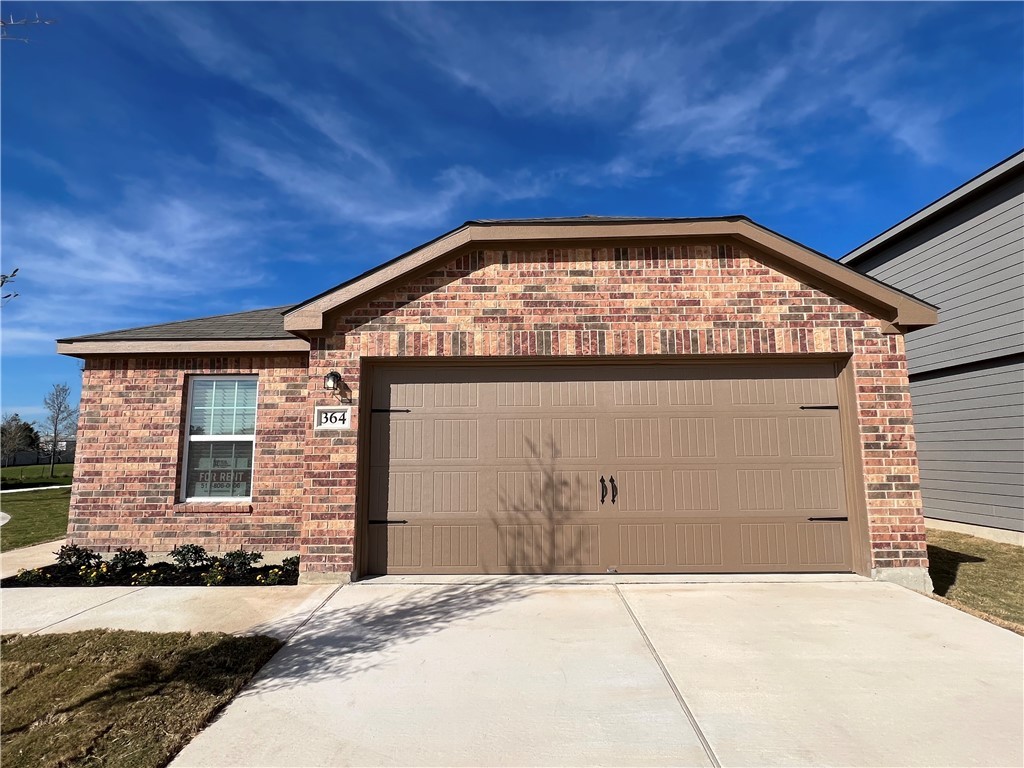 a front view of a house with garage