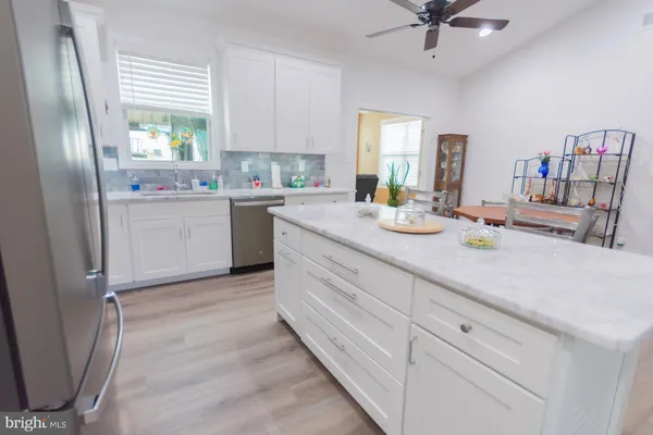 a kitchen with white cabinets and white appliances