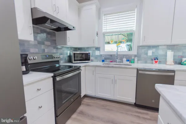 a kitchen with sink cabinets and window