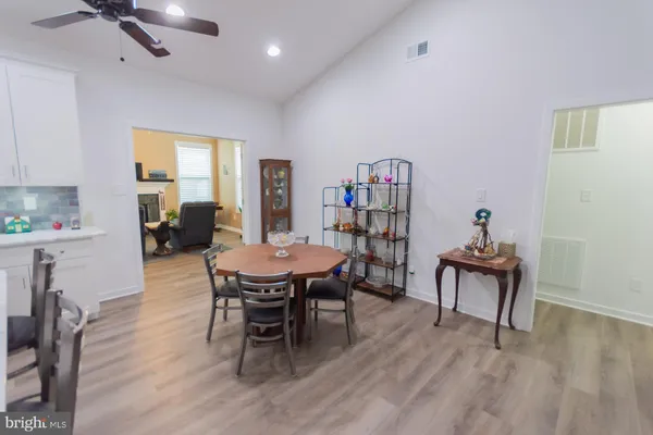 a kitchen with a refrigerator a stove a sink and dishwasher with wooden floor