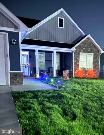 a front view of house with yard and outdoor seating