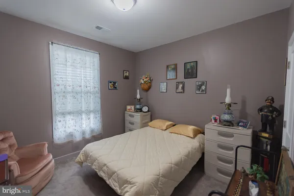 a bedroom with a bed and a chair