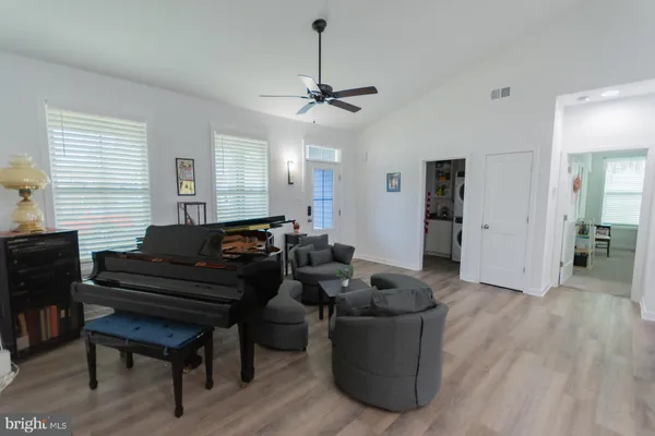 a living room with furniture and a wooden floor