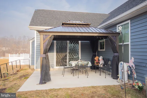 a front view of a house with a yard and seating space