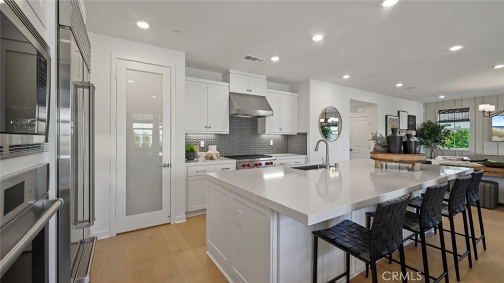 a kitchen with stainless steel appliances granite countertop a stove refrigerator sink and cabinets