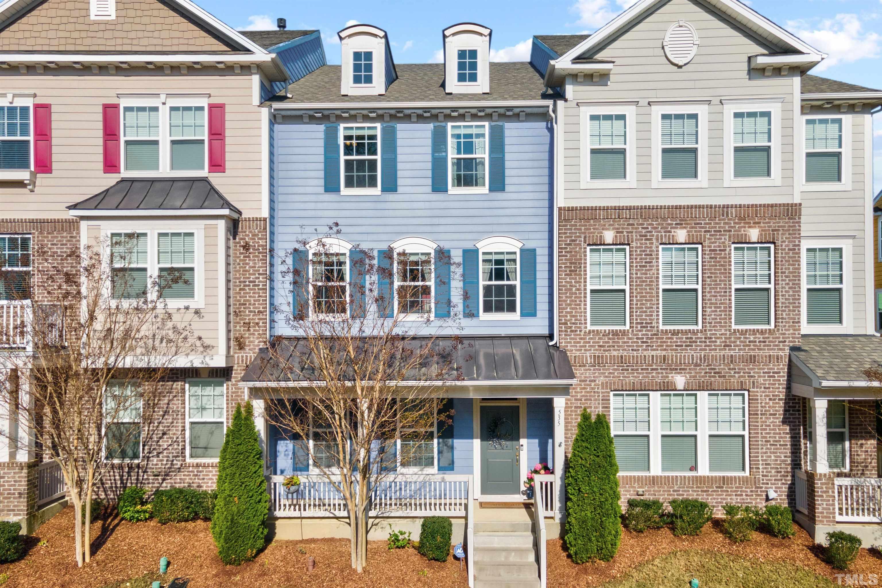 a front view of a residential apartment building with a yard