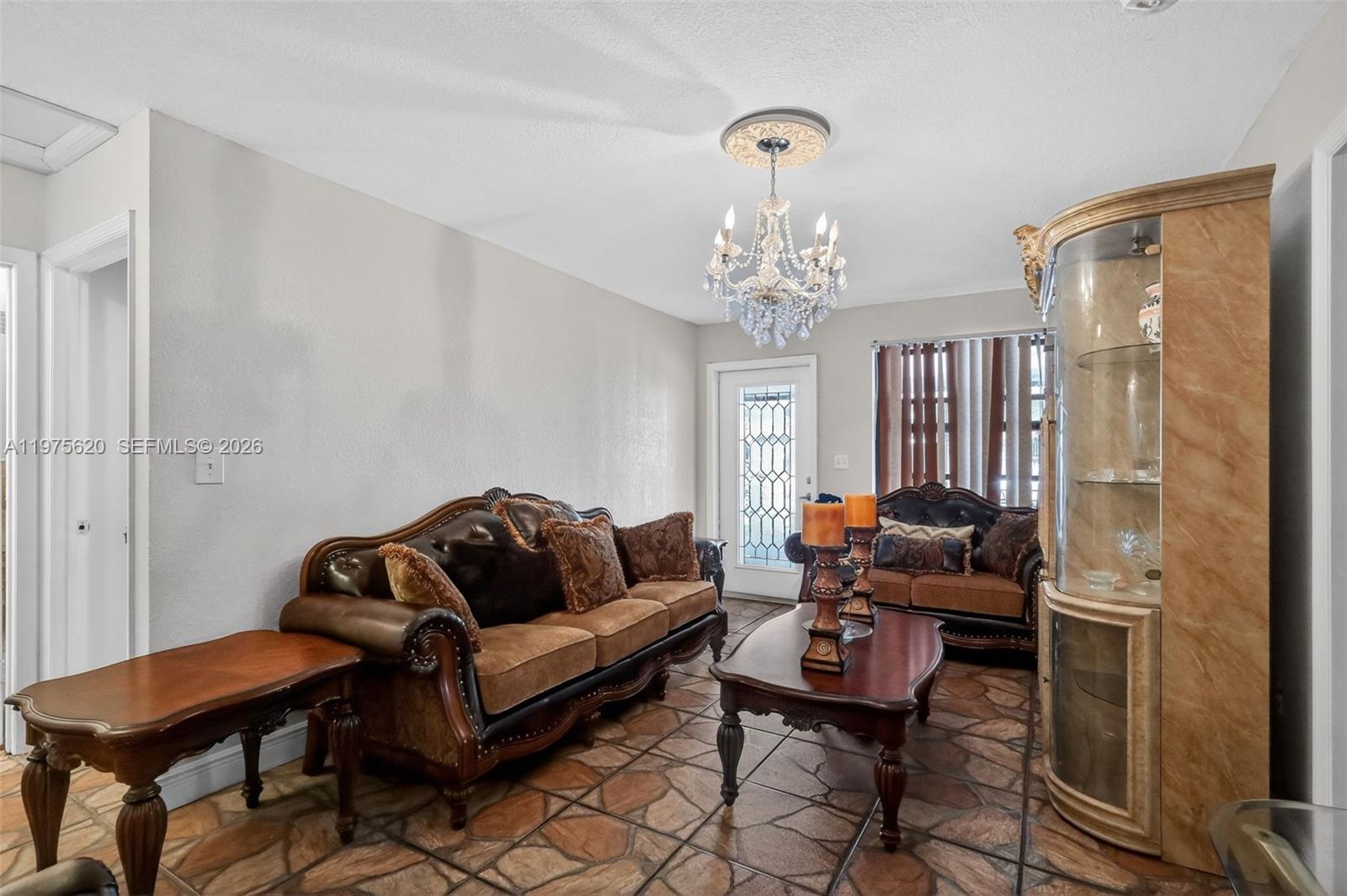 834 Northwest 115th Street Miami, FL 33168 - Photo 11 of 46 a living room with furniture and a chandelier