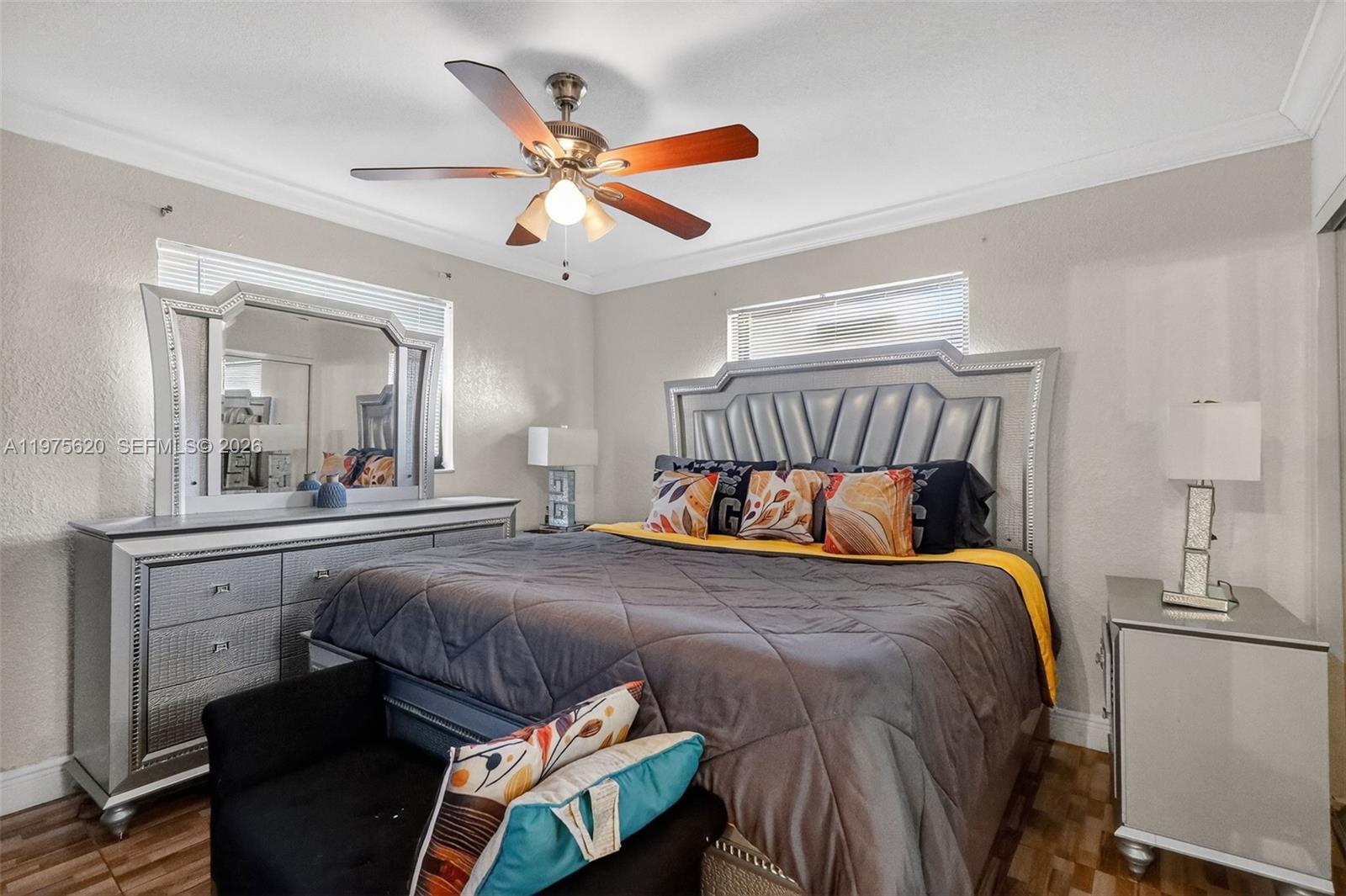 834 Northwest 115th Street Miami, FL 33168 - Photo 12 of 46 a bedroom with a bed and a chandelier