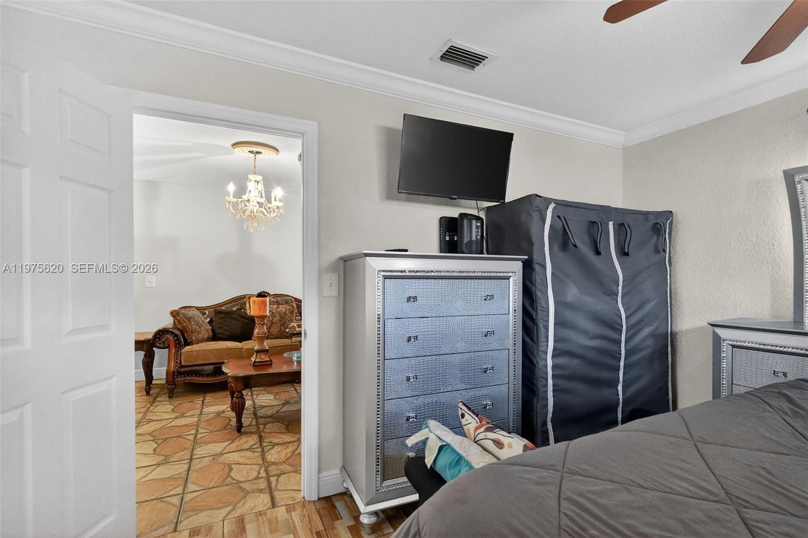 834 Northwest 115th Street Miami, FL 33168 - Photo 13 of 46 a bedroom with a bed and flat screen tv