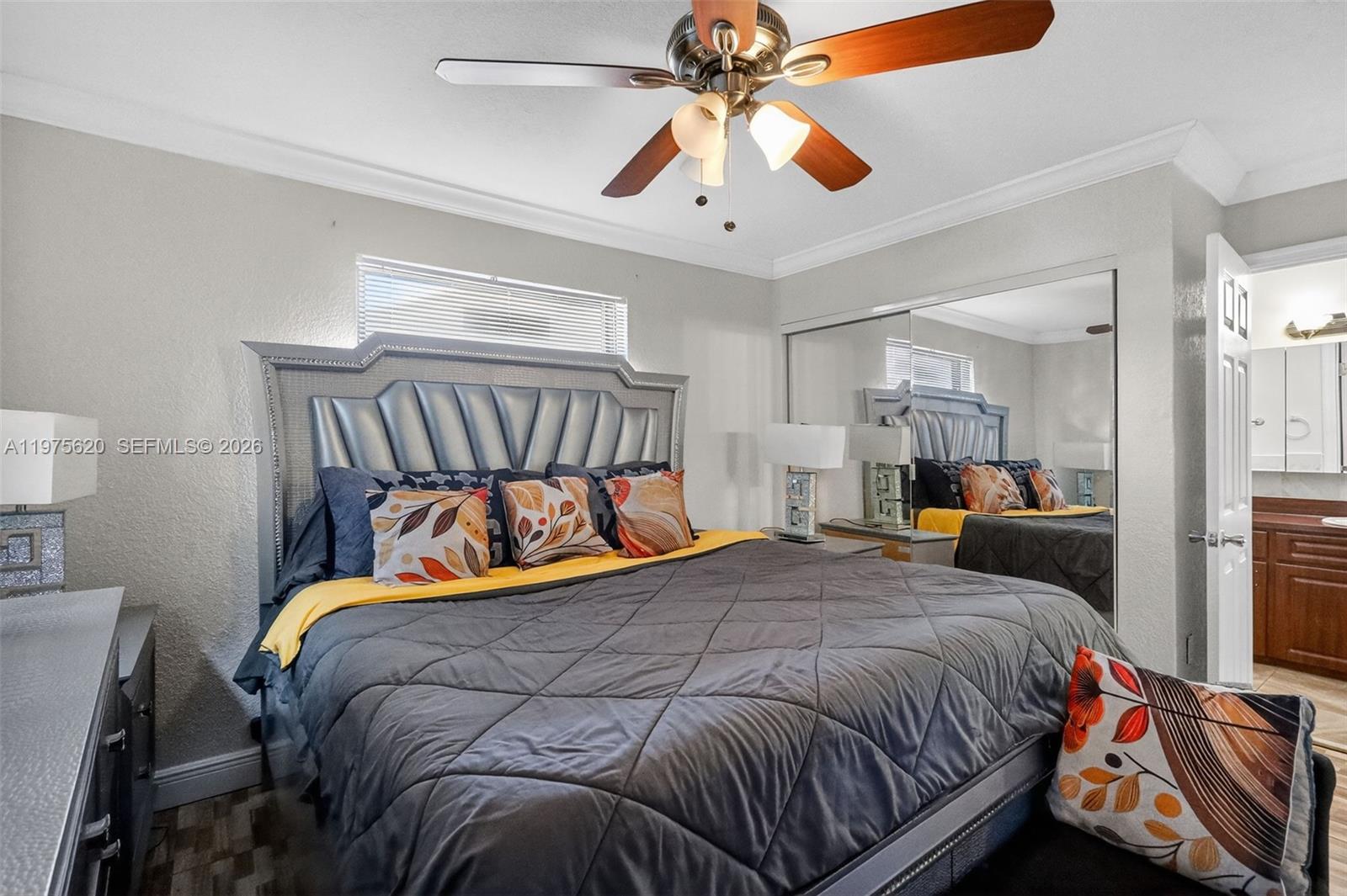 834 Northwest 115th Street Miami, FL 33168 - Photo 14 of 46 a bedroom with a bed and a chandelier