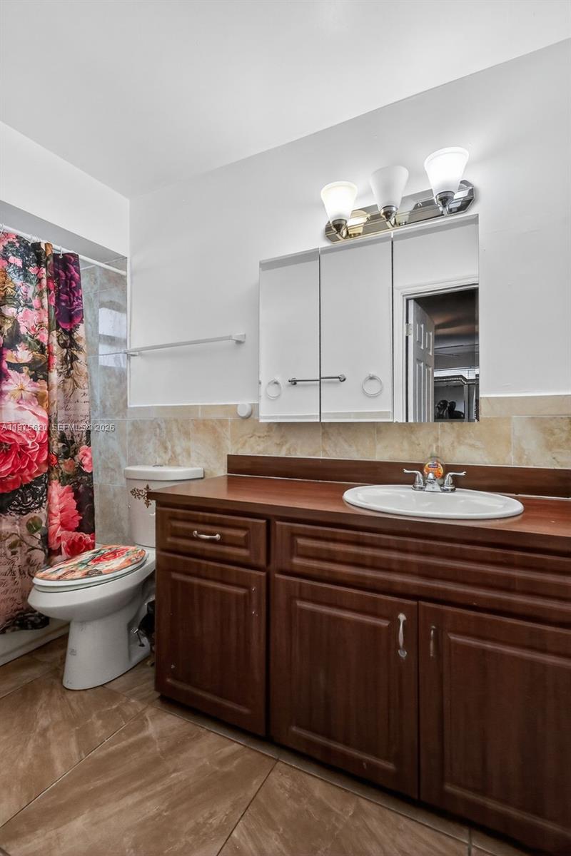 834 Northwest 115th Street Miami, FL 33168 - Photo 15 of 46 a bathroom with a sink and a mirror