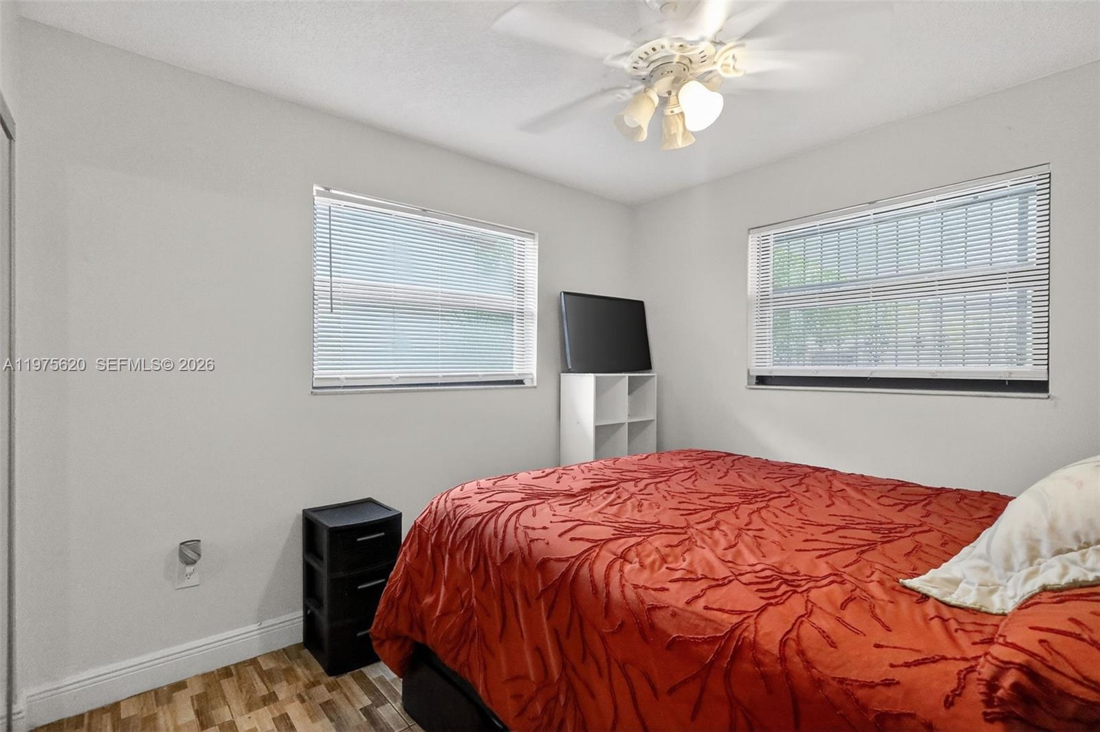 834 Northwest 115th Street Miami, FL 33168 - Photo 17 of 46 a bedroom with a bed and a lamp on dresser