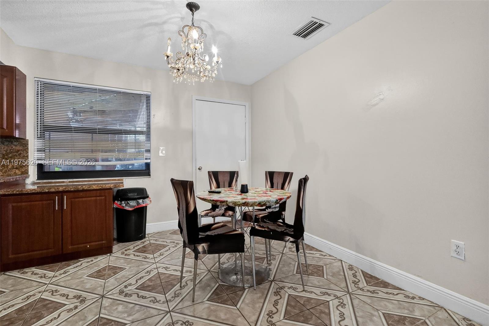 834 Northwest 115th Street Miami, FL 33168 - Photo 22 of 46 a dining room with furniture and window