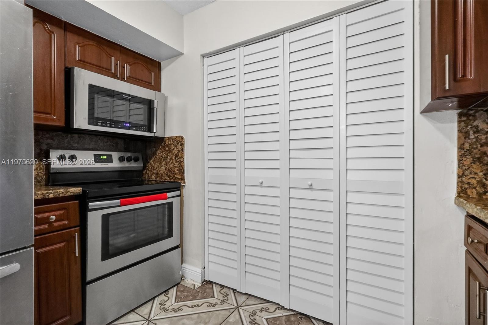 834 Northwest 115th Street Miami, FL 33168 - Photo 25 of 46 a kitchen with a stove and a microwave