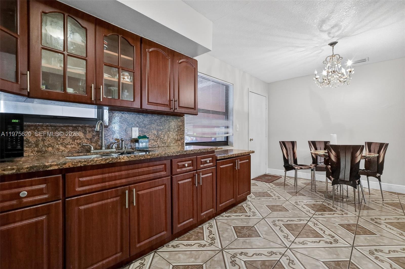 834 Northwest 115th Street Miami, FL 33168 - Photo 26 of 46 a kitchen with stainless steel appliances granite countertop a sink and cabinets