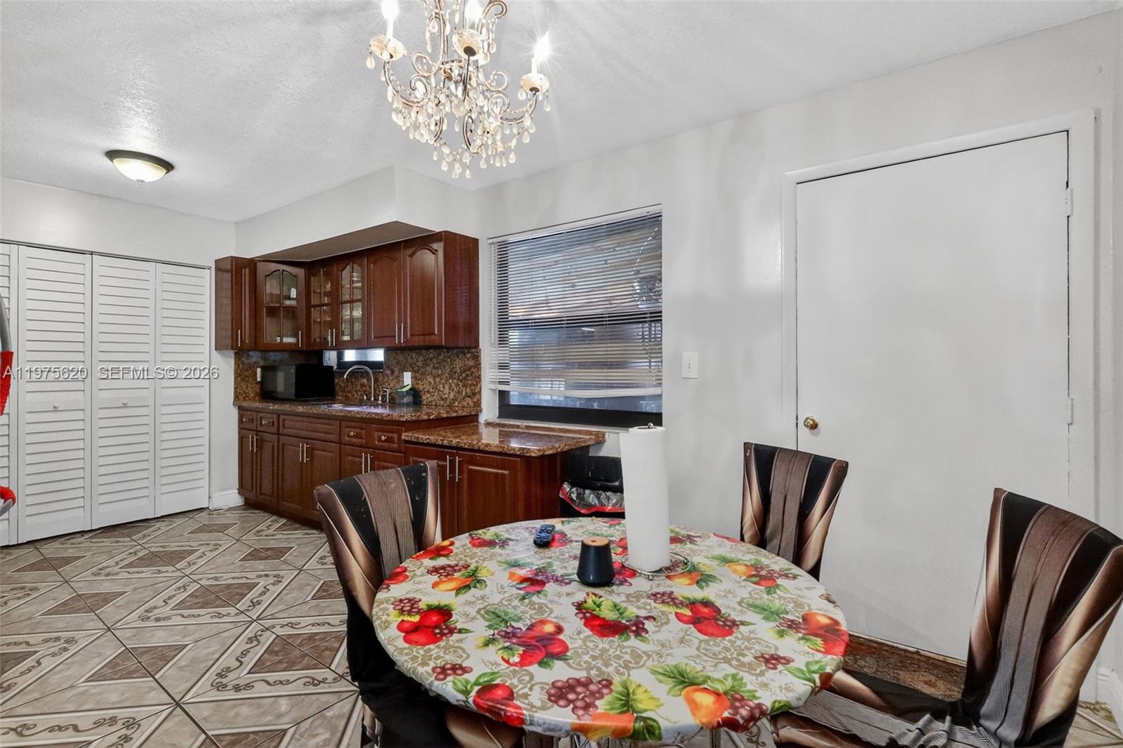 834 Northwest 115th Street Miami, FL 33168 - Photo 27 of 46 a bedroom with a bed and a table in it