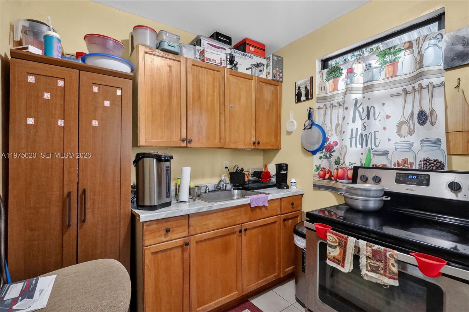 834 Northwest 115th Street Miami, FL 33168 - Photo 29 of 46 a kitchen with stainless steel appliances a sink a stove and a refrigerator