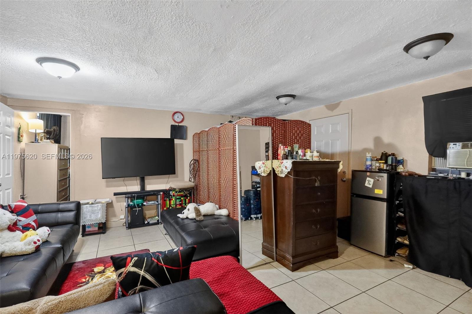 834 Northwest 115th Street Miami, FL 33168 - Photo 30 of 46 a living room with furniture and a flat screen tv