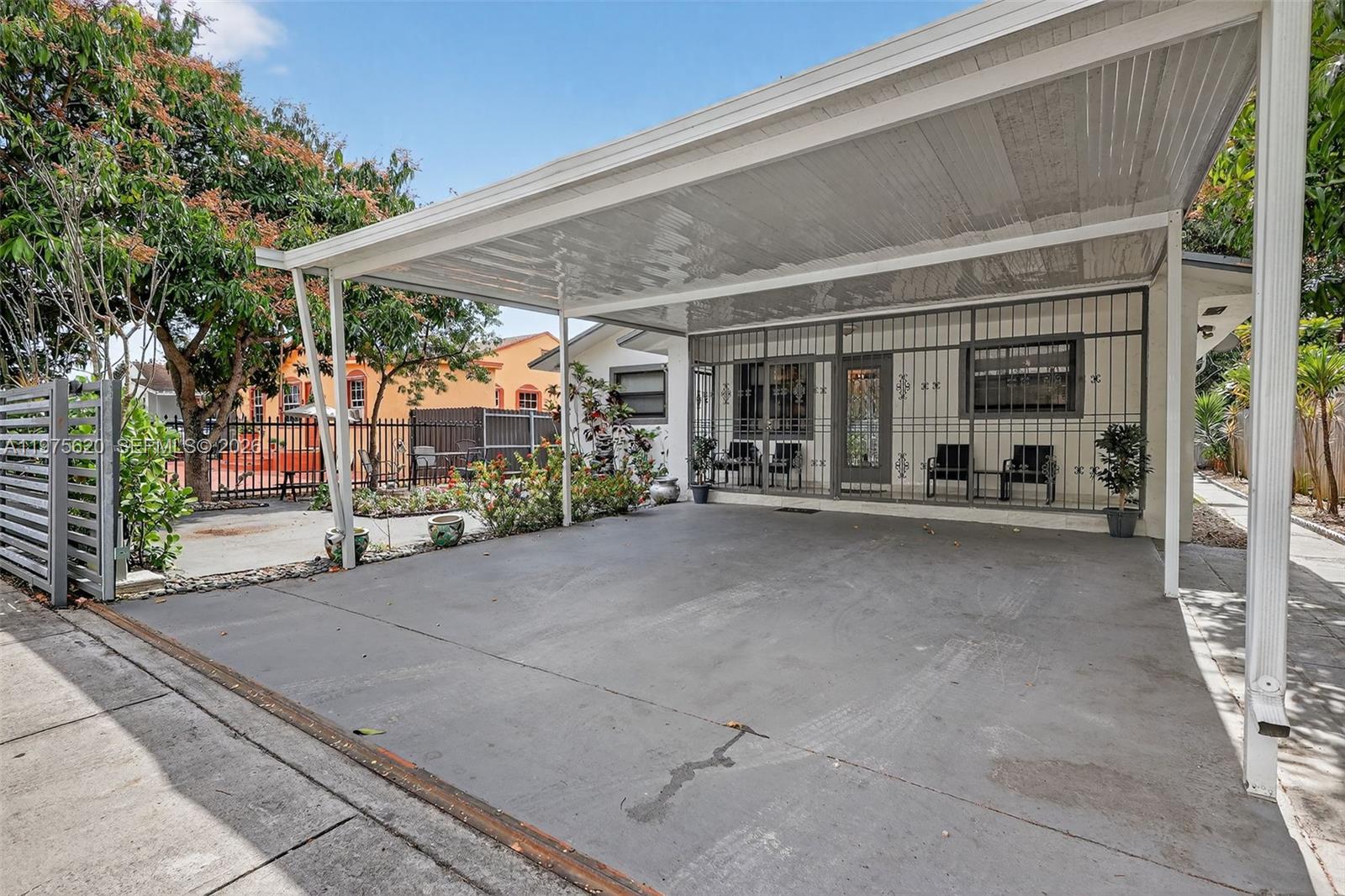 834 Northwest 115th Street Miami, FL 33168 - Photo 3 of 46 a view of a patio with table and chairs and floor to ceiling window